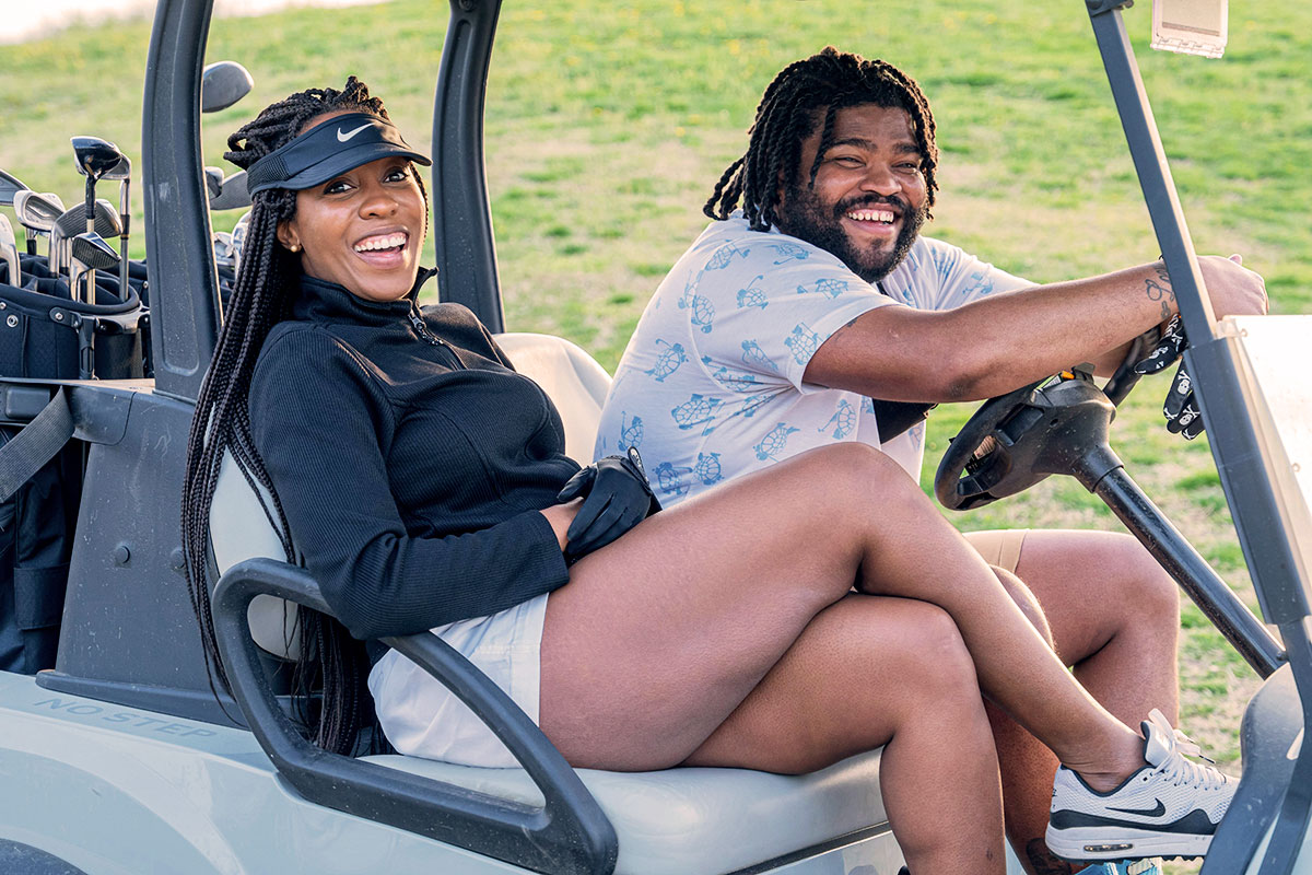 two golfers in golf cart