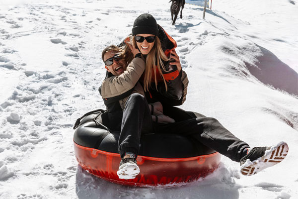 couple snow tubing together.