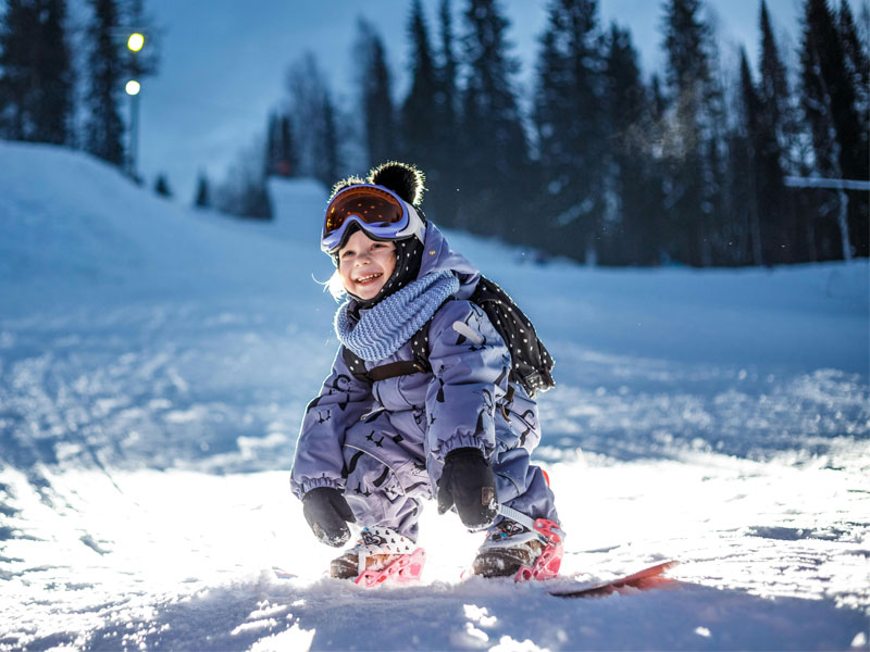 Small child on a snowboard